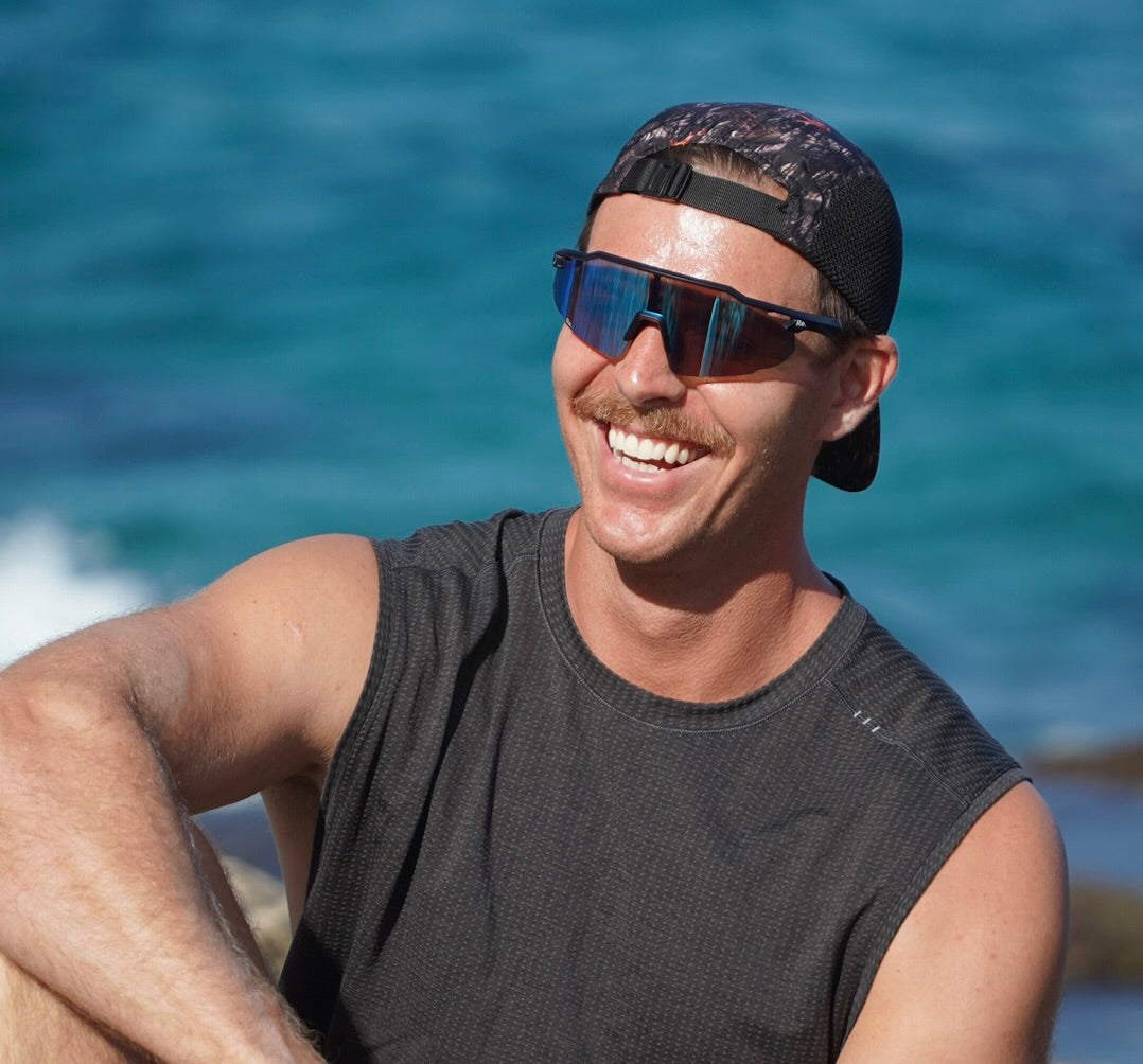 man smiling in running sunglasses